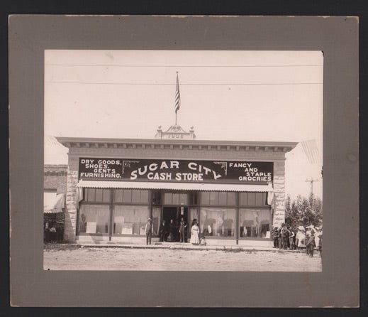 Item #46901 Sugar City, Idaho. Sugar City Cash Store. Dry Goods, Shoes, Gents Furnishing. Fancy and Staple Groceries. Large photograph.